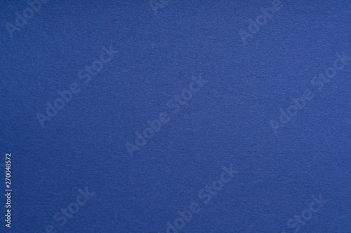 Paper background blue color. Rough paper texture. Closeup. Macro.