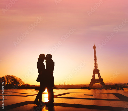 travel to Paris, honeymoon getaway to France, Europe, silhouette of romantic couple kissing near Eiffel tower © Song_about_summer