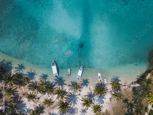 paradise tropical beach with turquoise sea water and palm trees, aerial drone top view beautiful landscape photo