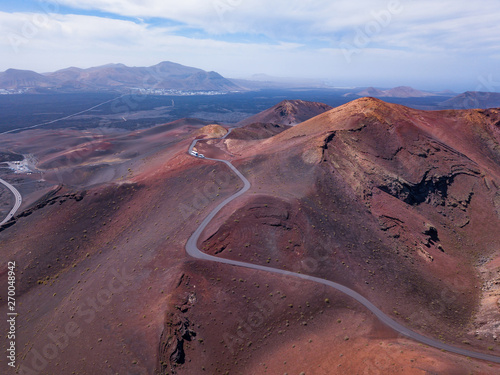 red volcanic mountains with craters in Timanfaya national park in Lanzarote island, aerial view landscape of Canary islans, nature in Spain
