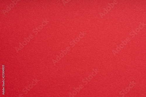 Paper background red color. Rough paper texture. Closeup. Macro.