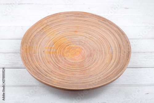 WOODEN PLATE ON WHITE TABLE