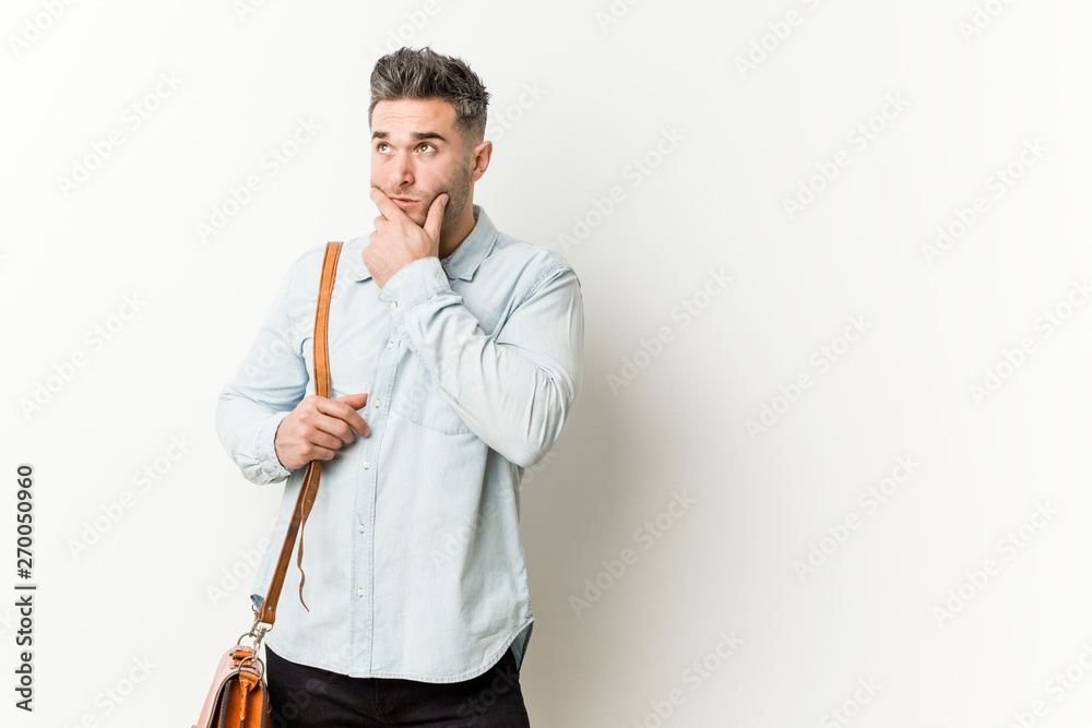 Young handsome business man looking sideways with doubtful and skeptical expression. Young handsome business man looking sideways with doubtful and skeptical expression.