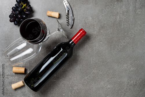 Bottle of wine and bowl on concrete background.