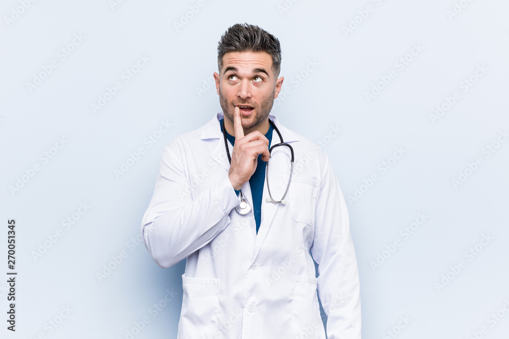 Young handsome doctor man looking sideways with doubtful and skeptical expression. Young handsome doctor man looking sideways with doubtful and skeptical expression.