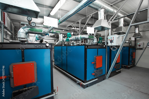 water-heating solid fuel boilers installed in a row in boiler room