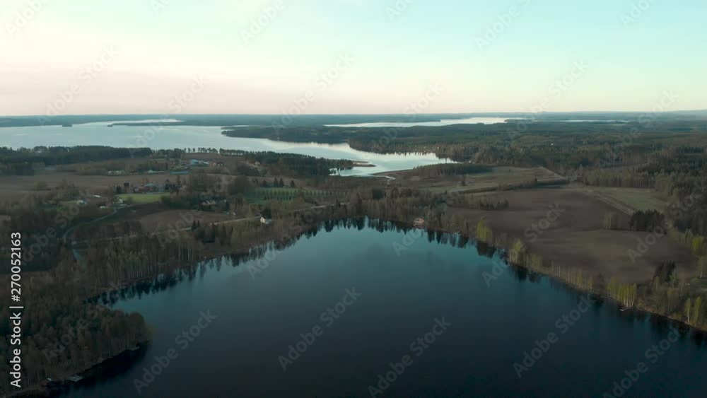 Aerial, drone shot, over lake Sarkinen, towards Iso-sapsojarvi, on a sunny, spring day, in Sotkamo, Kainuu, Finland Aerial, drone shot, over lake Sarkinen, towards Iso-sapsojarvi, on a sunny, spring day, in Sotkamo, Kainuu, Finland