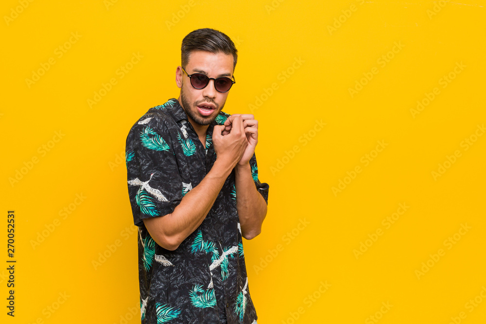 Young filipino man wearing summer clothes scared and afraid. Young filipino man wearing summer clothes scared and afraid.