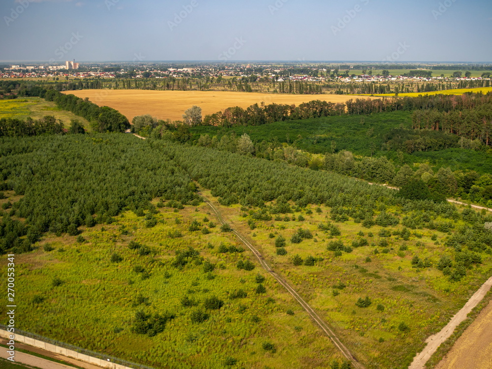 Aerial rural nature scene and far side visible city Aerial rural nature scene and far side visible city