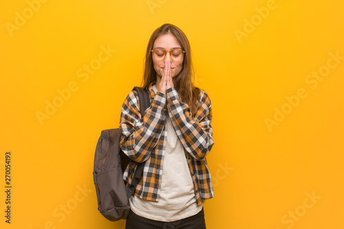 Young student woman praying very happy and confident © Asier