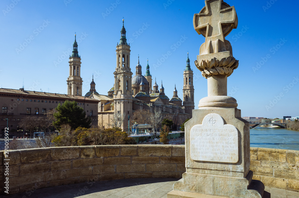 Zaragoza, Aragon, Spain - February 14th, 2019 : Basilica of Our Lady of the Pillar as seen from the Puente de Piedra (Stone bridge) over the river Ebro. 