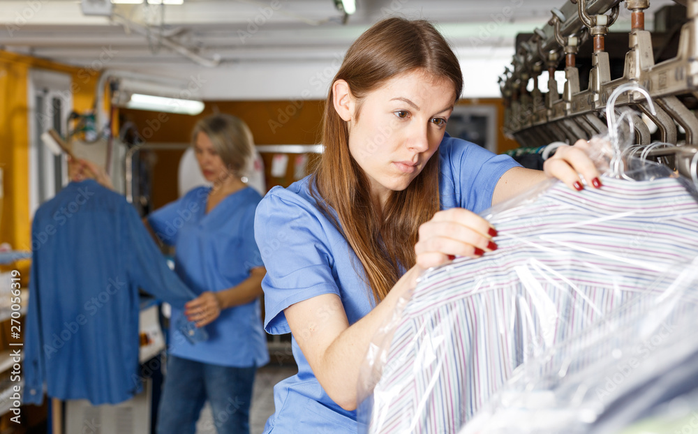 Obraz premium Two women working at dry-cleaning salon