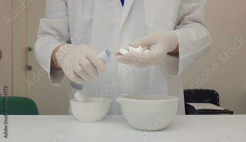 Pharmacist performing a quality control of effervescent tablets © enriscapes