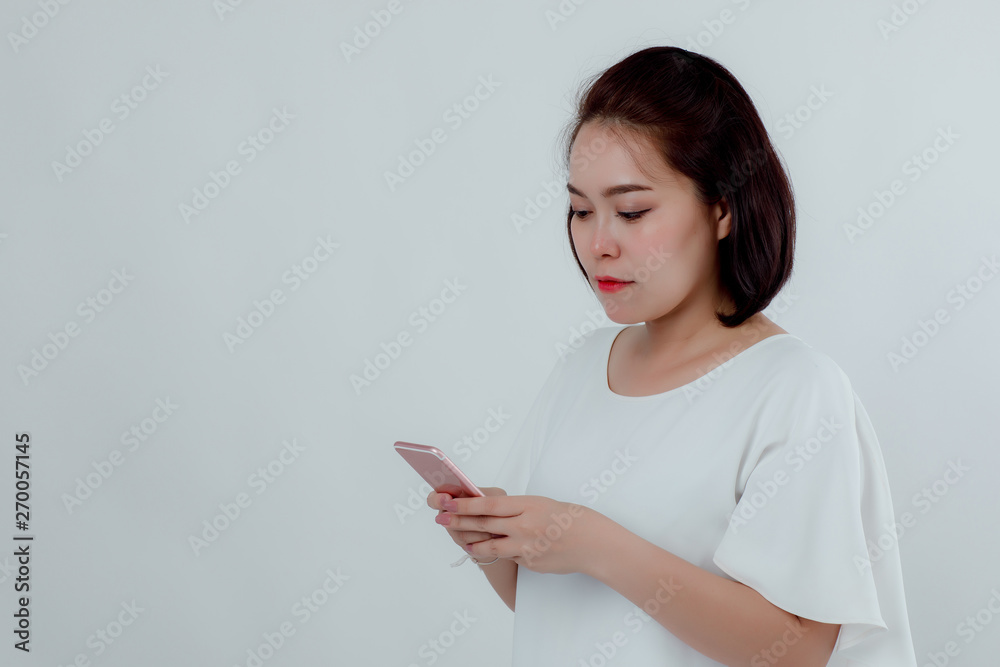 Asian beautiful woman Standing in a white shirt Mobile phone stand press Prepare to make a call. With a happy smile With a white background Asian beautiful woman Standing in a white shirt Mobile phone stand press Prepare to make a call. With a happy smile With a white background