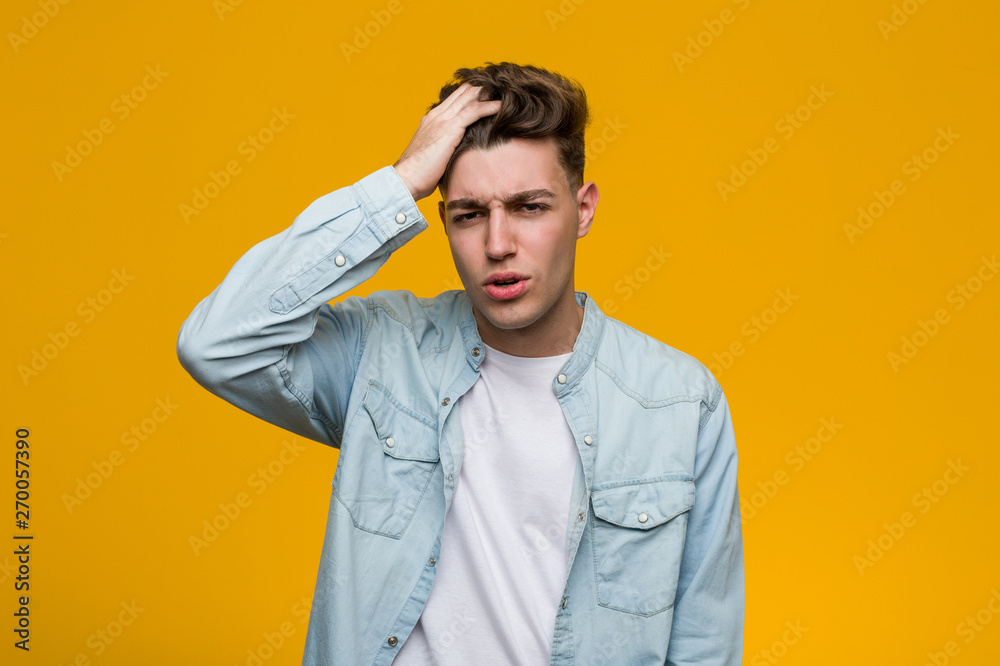 Young handsome student wearing a denim shirt tired and very sleepy keeping hand on his head. Young handsome student wearing a denim shirt tired and very sleepy keeping hand on his head.