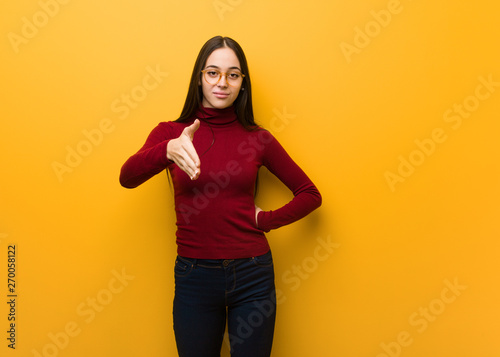 Intellectual young girl reaching out to greet someone