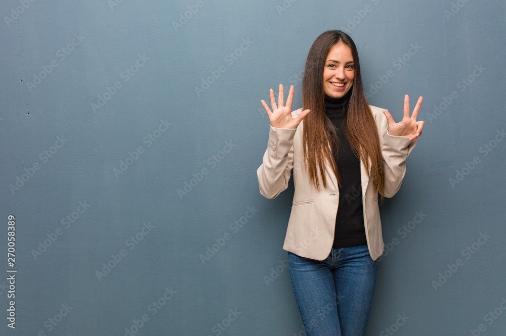 Young business woman showing number eight Young business woman showing number eight