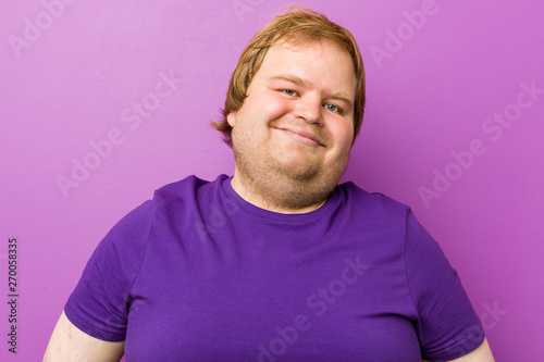 Young authentic redhead fat man confident keeping hands on hips.