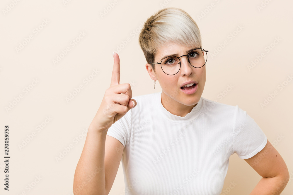 Young authentic natural woman wearing a white shirt having an idea, inspiration concept. Young authentic natural woman wearing a white shirt having an idea, inspiration concept.
