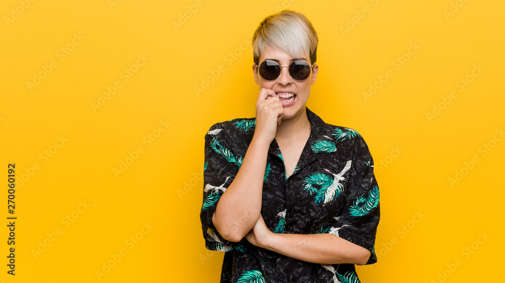 Young curvy woman wearing a summer look biting fingernails, nervous and very anxious. Young curvy woman wearing a summer look biting fingernails, nervous and very anxious.