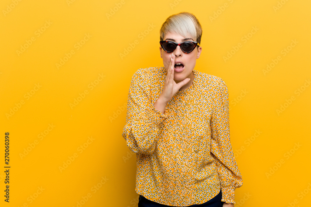 Fototapeta premium Young curvy woman wearing a floral summer clothes is saying a secret hot braking news and looking aside