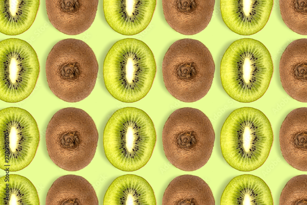 Fototapeta premium kiwi fruit sliced pattern on green background