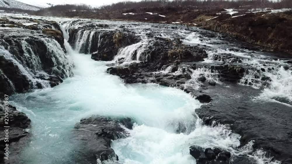 Arial view of Bruarfoss Waterfall in Iceland by far has the most blue water of all the waterfalls on the Golden Circle. Arial view of Bruarfoss Waterfall in Iceland by far has the most blue water of all the waterfalls on the Golden Circle.