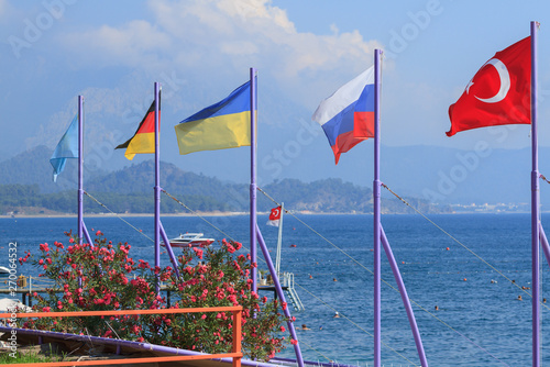 Flags of Turkey, Russia, Ukraine, Germany and Kazakhstan on the beach in Kemer