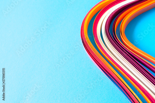 Abstract blue background with orange, burgundy and white stripes.