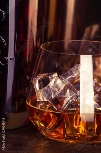 a glass of whiskey on wooden table