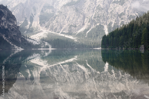 perfect mountain and forest reflection in the lago di braies, italy