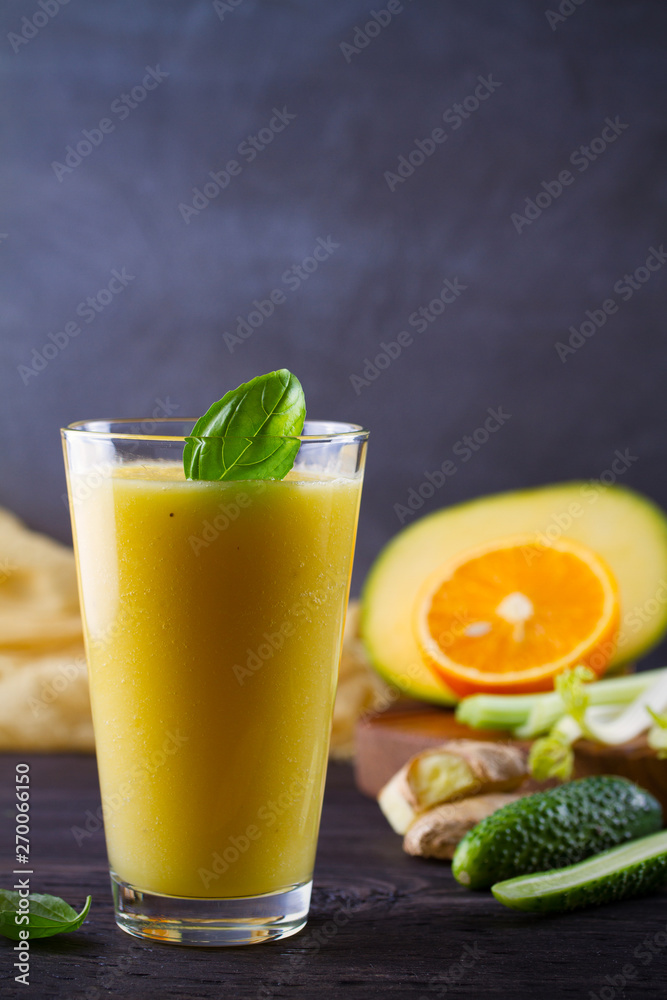 Mango Orange Ginger Cucumber and Celery Smoothie. Fruit and Vegetable Smoothie - healthy diet and detox drink. vertical Mango Orange Ginger Cucumber and Celery Smoothie. Fruit and Vegetable Smoothie - healthy diet and detox drink. vertical