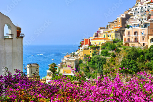Colorful flowers and buildings looking out to sea in the coastal town of Positano, Amalfi Coast, Italy
