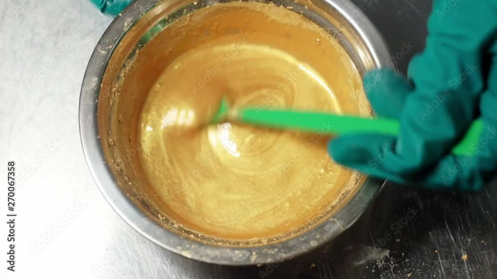 Production of shampoo. Stirring the mixture of an ochre soapy liquid Production of shampoo. Stirring the mixture of an ochre soapy liquid