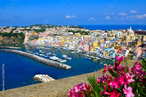 Colorful island town in Italy. Above view overlooking Procida from a flower filled terrace.