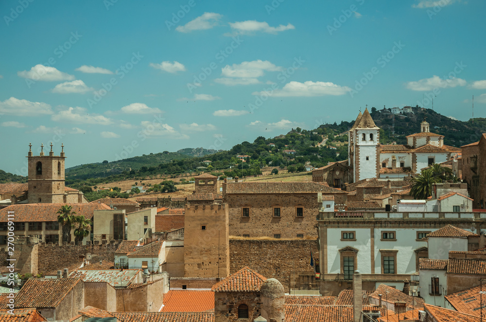 Cityscape with old building roofs and church bell tower at Caceres