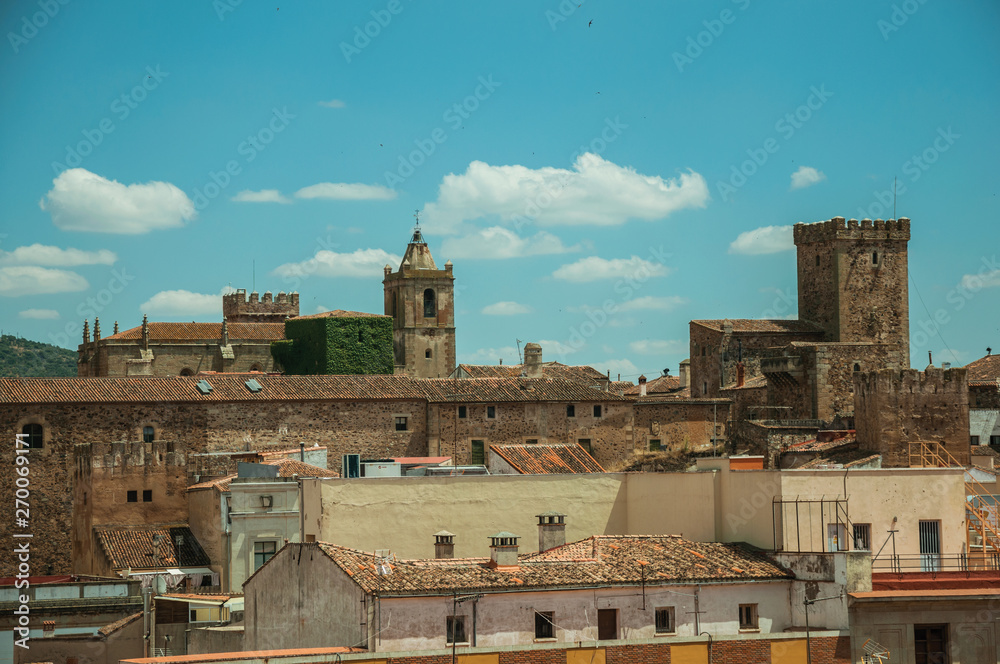 Fototapeta premium Cityscape with old building roofs and church bell tower at Caceres