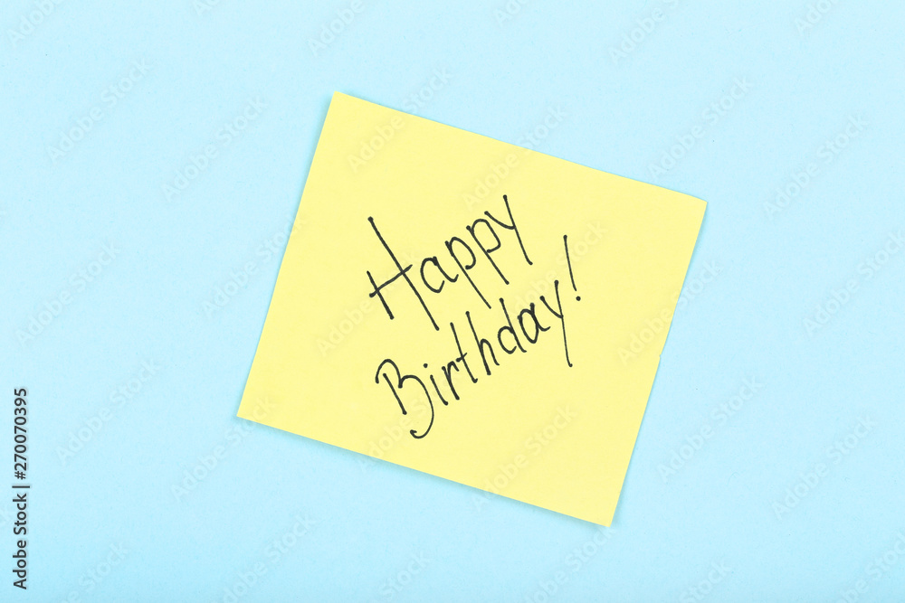 Paper with text Happy Birthday on blue background Paper with text Happy Birthday on blue background