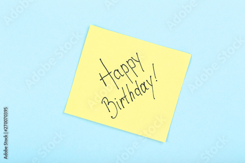 Paper with text Happy Birthday on blue background