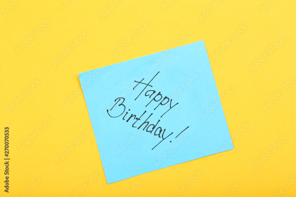 Paper with text Happy Birthday on yellow background Paper with text Happy Birthday on yellow background