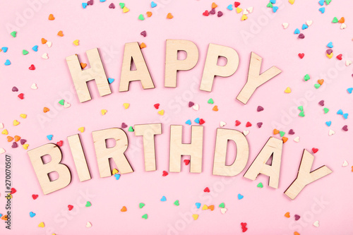 Text Happy Birthday with small hearts on pink background