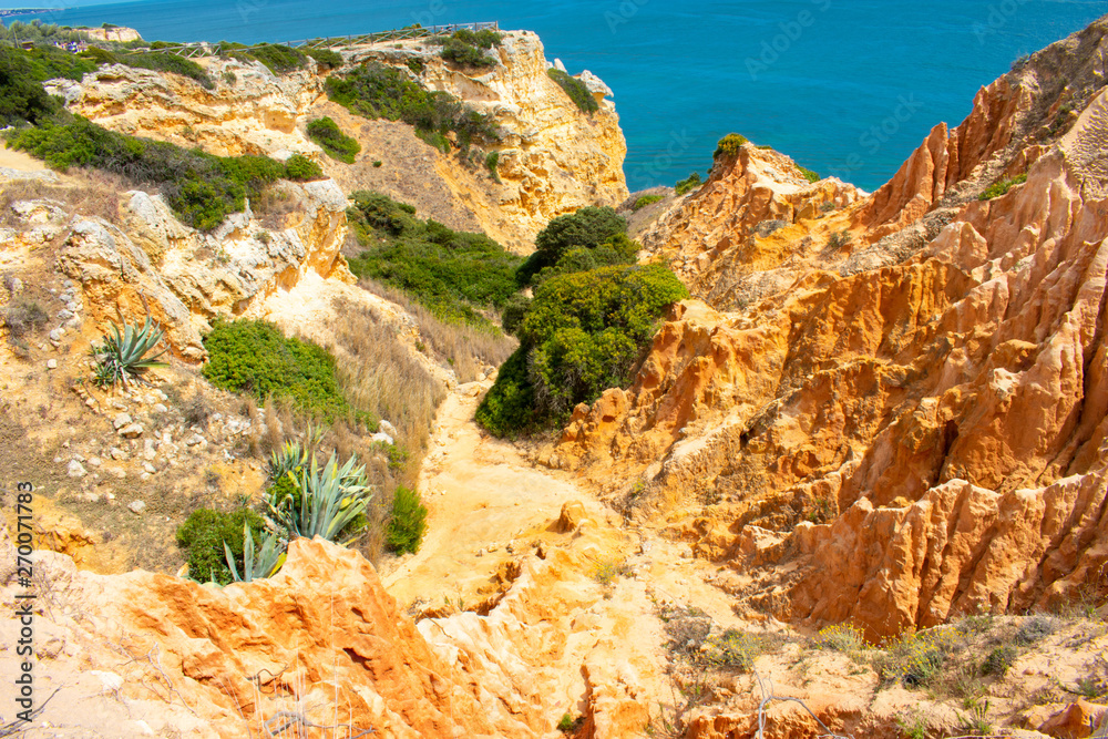 Rock formations on coast of Atlantic Ocean in Lagoa, Algarve Portugal