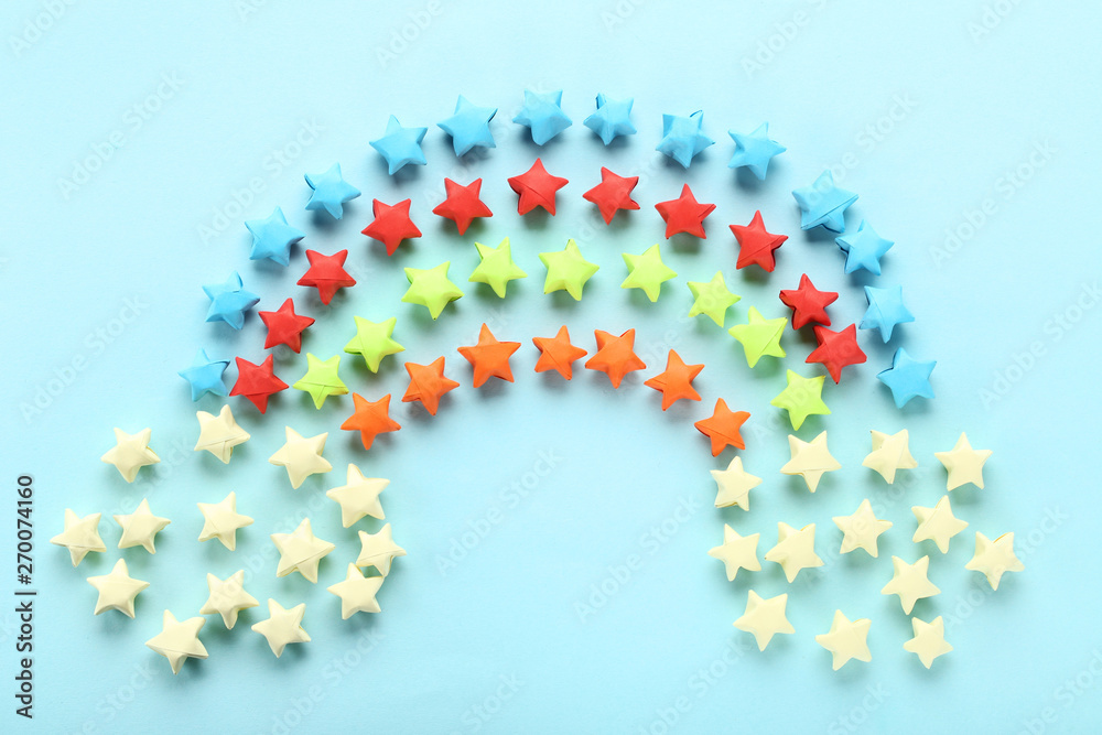 Colorful paper stars on blue background