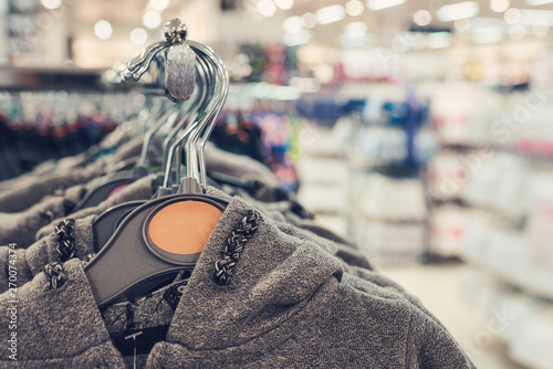 Casual clothes on hangers in a shopping mall.