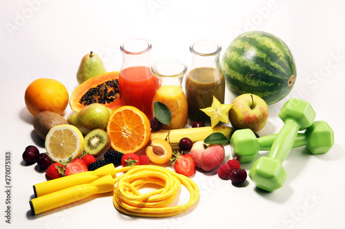 Healthy lifestyle concept. healthy fruits  smoothies and sport fitness equipment  dumbbells and jumping rope