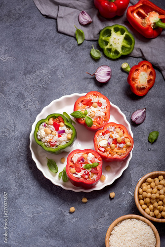 Stuffed vegetarian peppers or paprika with rice and chickpeas, vegan cooking, healthy summer lunch