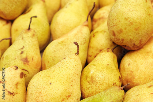 A large group of yellow pears close-up