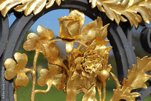 London. Golden Gate located on the side of Kensington Palace with palace in background during day of Spring
