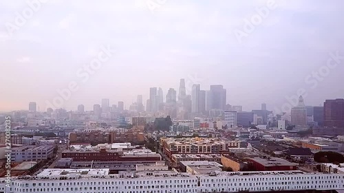 Aerial drone footage of downtown Los Angeles covered in smog pollution. Overcast gloomy day. photo