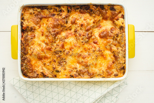 Lasagna Bolognese with Beef, Cheese and Tomato Sauce on Rustic White Table